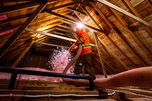 Blown-in insulation being installed in an attic